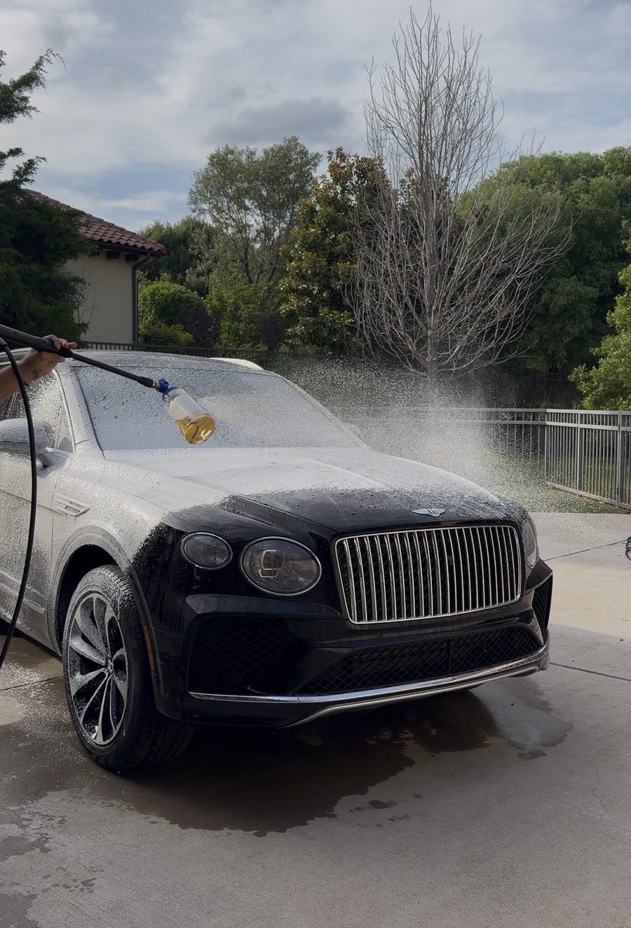Luxury SUV covered in foam during an exterior wash