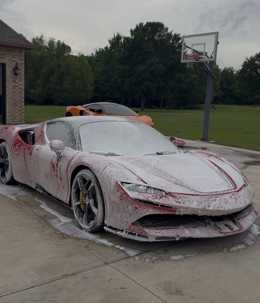 Ferrari SF90 covered in snow foam during an MTO Auto Detailing hand wash, McLaren in the background