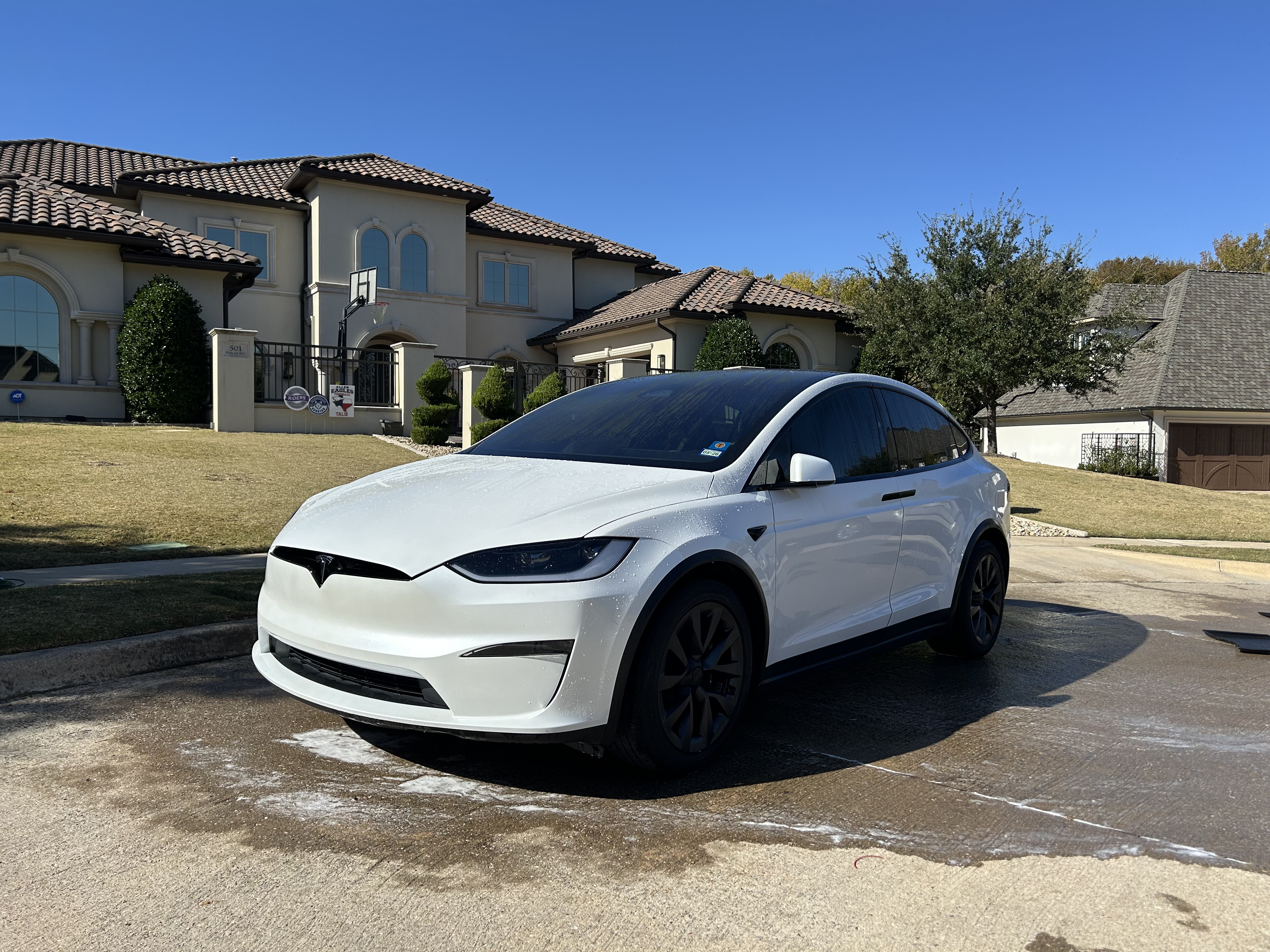 White SUV freshly detailed outside a Texas home
